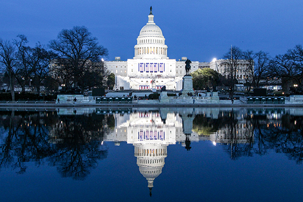 Photo of capitol building reflected in water at night
